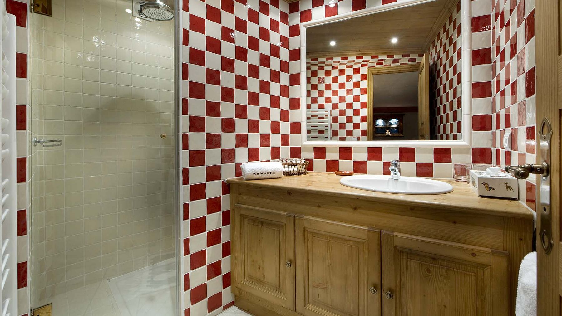 Bathroom in red and white and wooden vanity