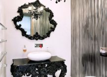 Beautifully-crafted-black-table-with-ornate-design-acts-as-vanity-in-this-glamorous-powder-room-217x155