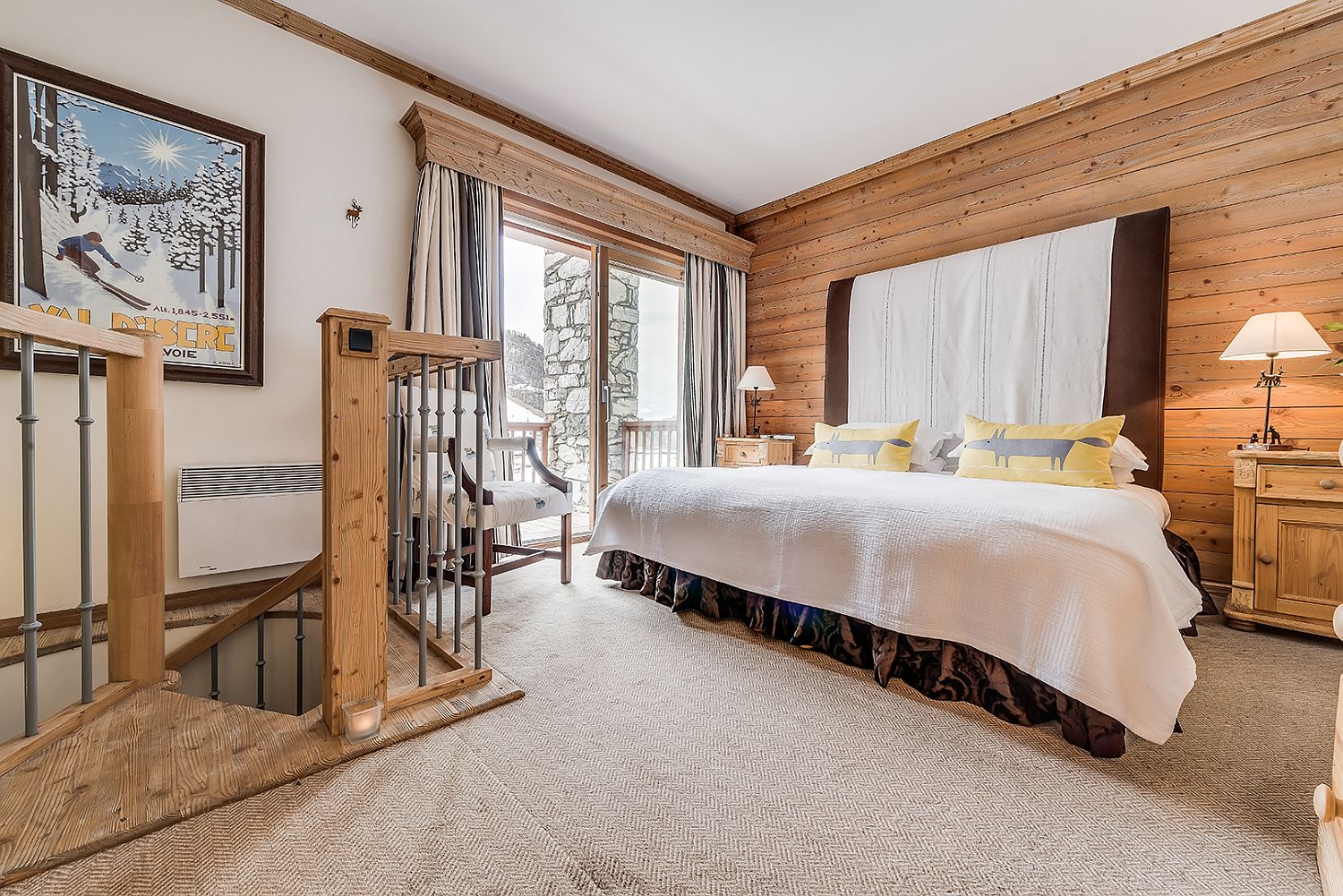 Bedroom of the chalet with a small balcony