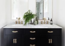 Black-vanity-with-brass-handles-fixtures-and-a-white-marble-countertop-217x155