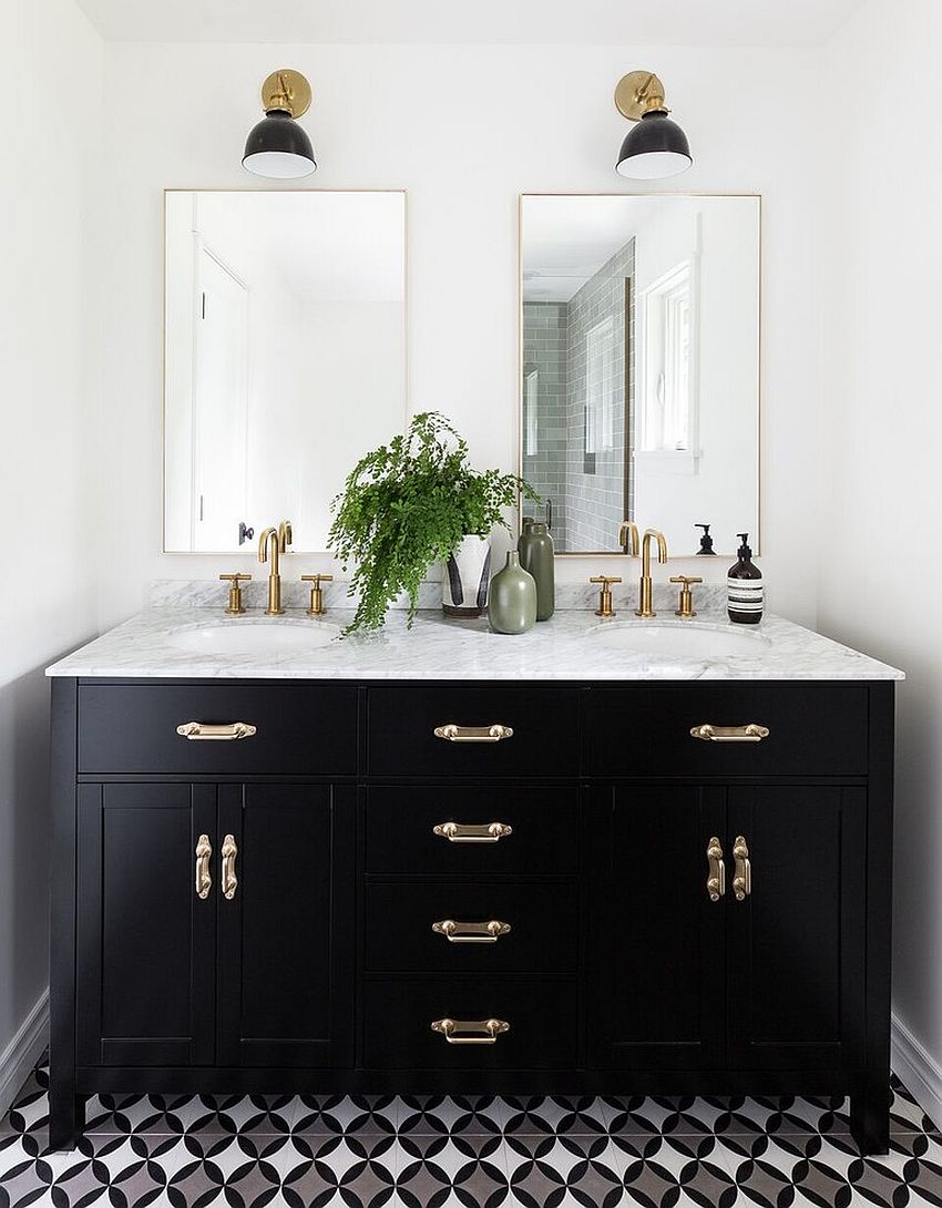 Black vanity with brass handles, fixtures and a white, marble countertop