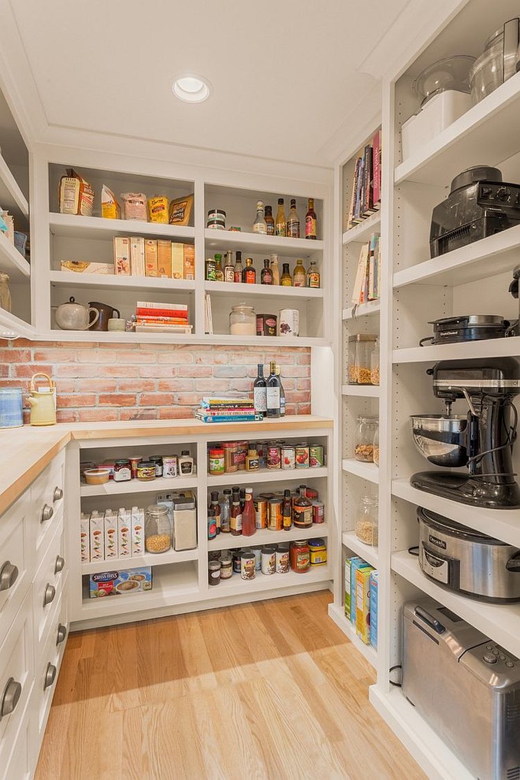 Brick wall section of the pantry adds textural beauty to the space