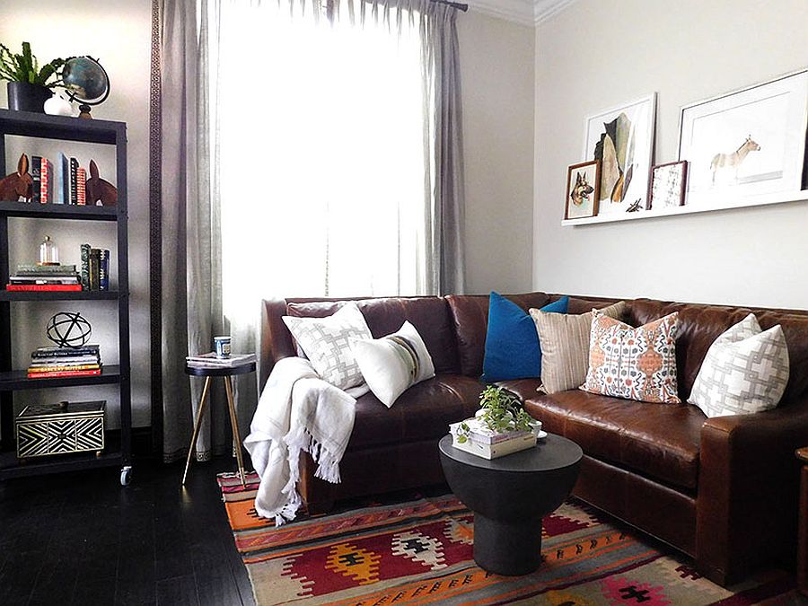 Brown sectional coupled with a colorful rug full of pattern