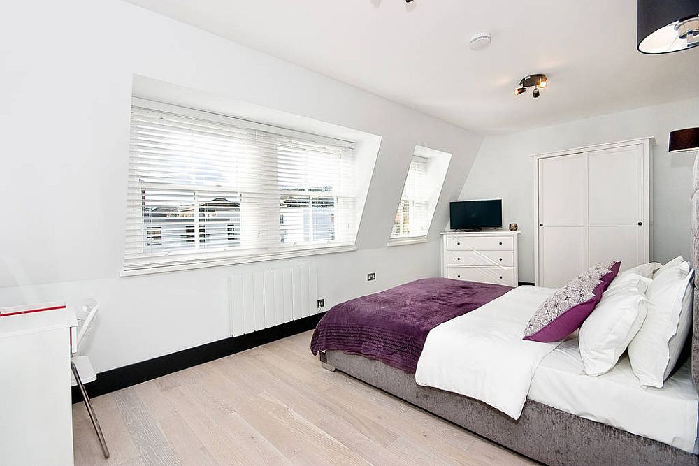 Cheerful and light-filled bedroom in white with purple accents