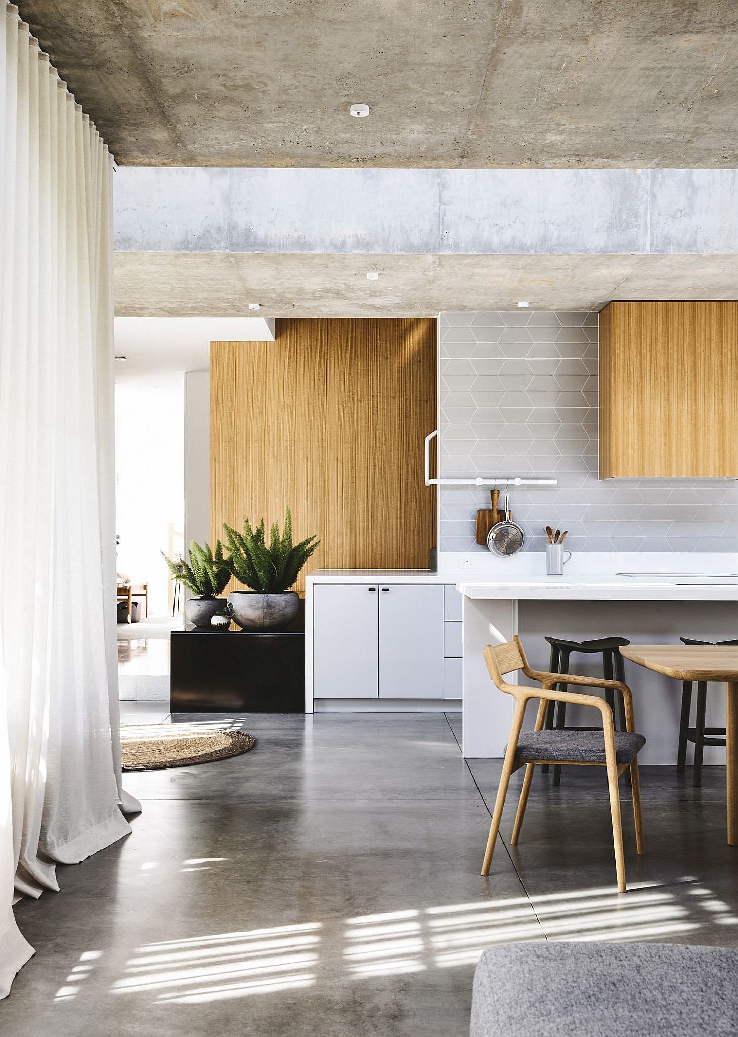 wood shelves accent concrete ceiling in kitchen