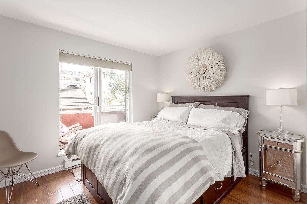 Contemporary bedroom in white with tiny balcony