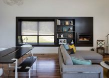Dark-accent-wall-in-the-living-room-with-fireplace-and-a-window-seat-217x155