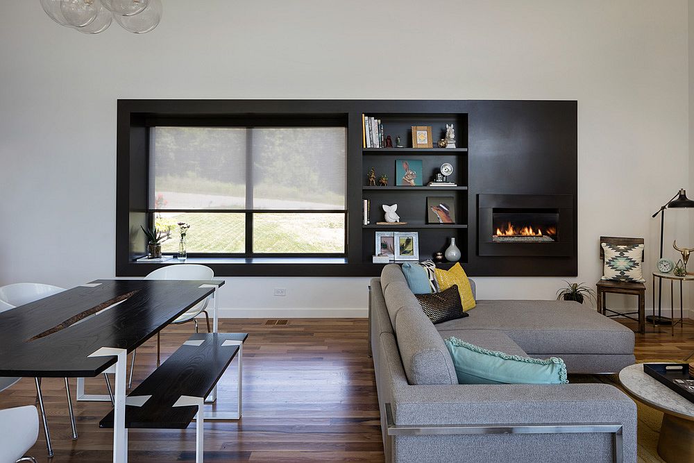 Dark-accent-wall-in-the-living-room-with-fireplace-and-a-window-seat