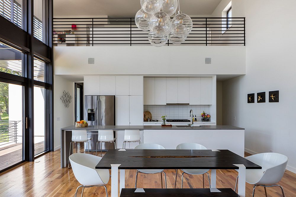 Dark framed windows anchor an otherwise light and breezy kitchen in white