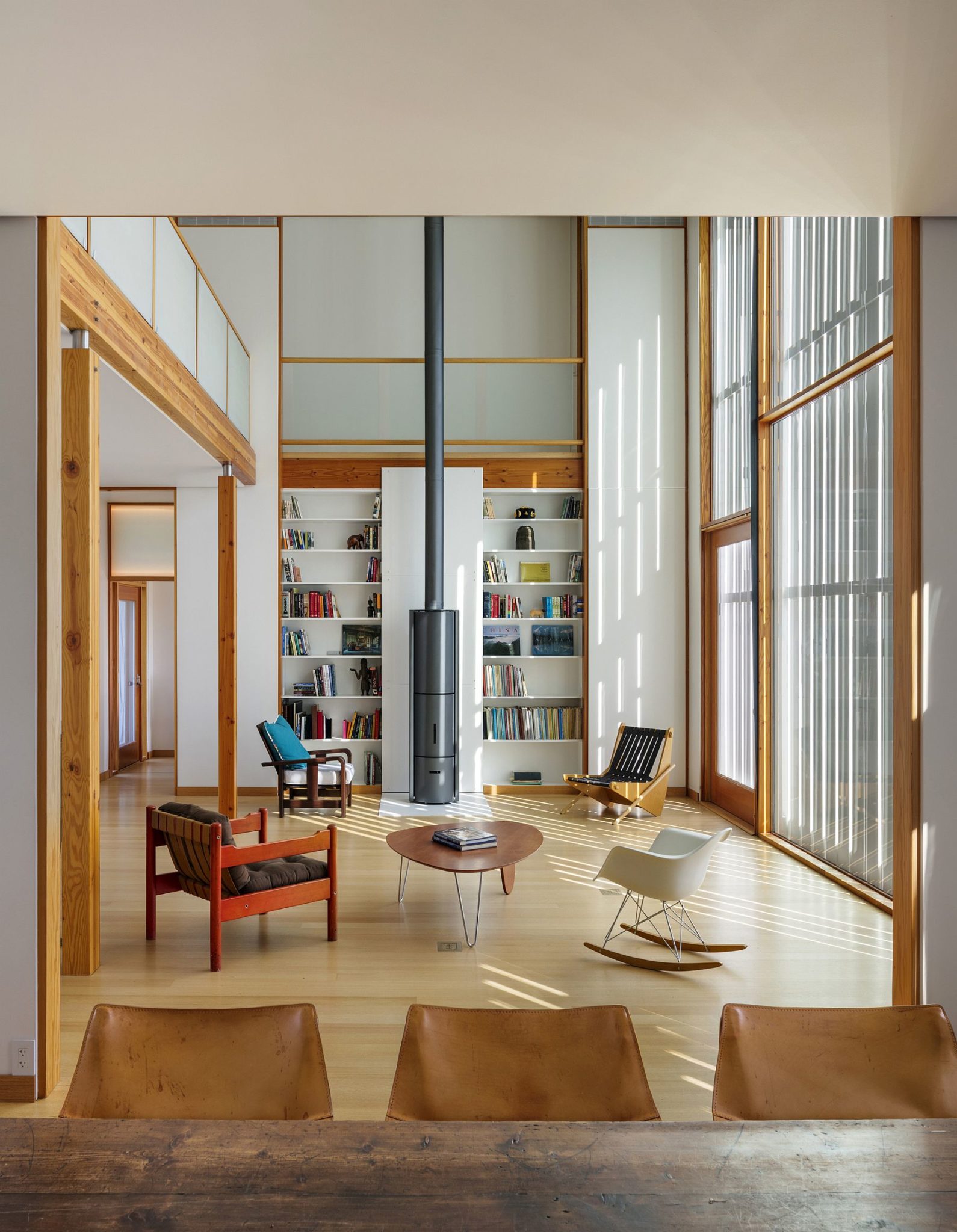 Double height living area of the farmhouse in white with wooden accents