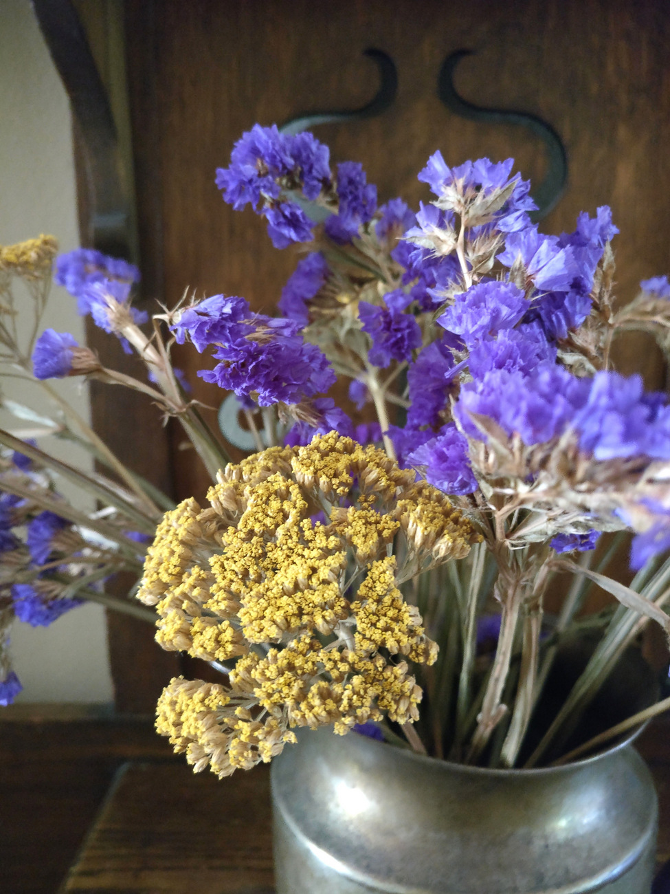 Dried flowers in a silver pitcher