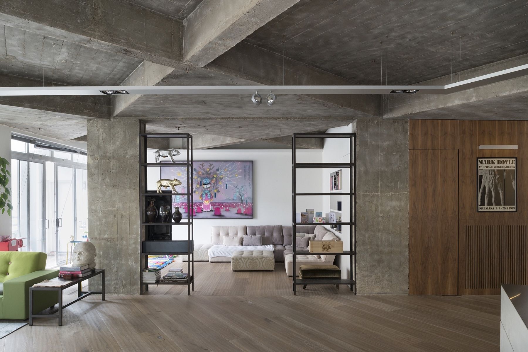 Exposed concrete walls and wooden flooring shape a stylish industrial loft