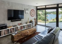 Family-room-with-a-rustci-wooden-coffee-table-and-a-concrete-wall-217x155