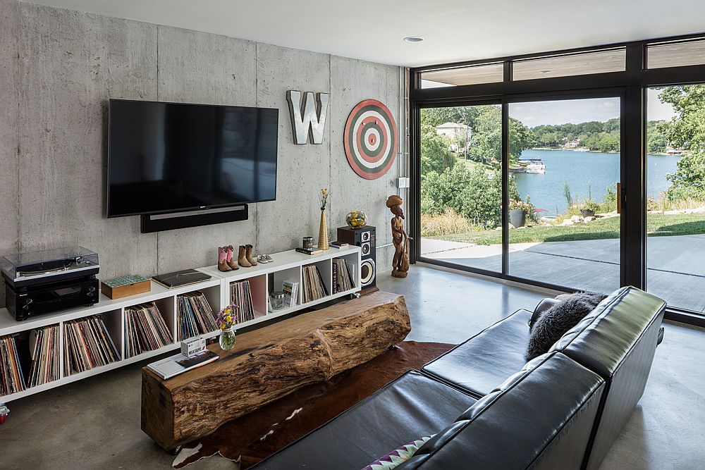 Family room with a rustic wooden coffee table and a concrete wall