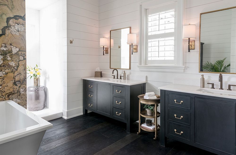 Farmhouse style bathroom with stone wall and twin black vanities