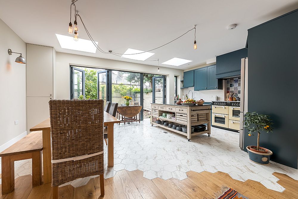 Floor tiles are used to separate space visually in this chic London home