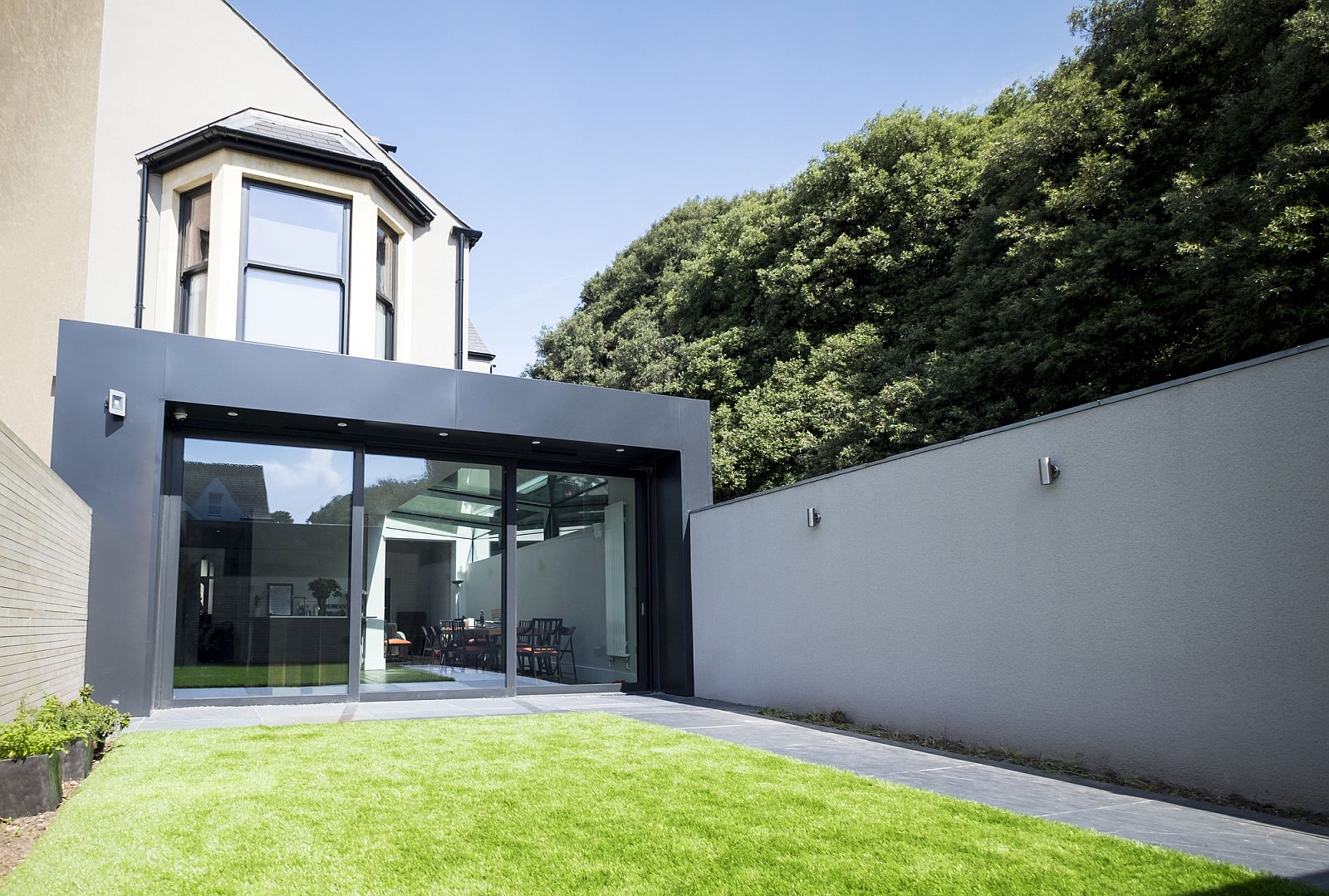 Glass and dark aluminum extension for an old Victorian House in Cardiff