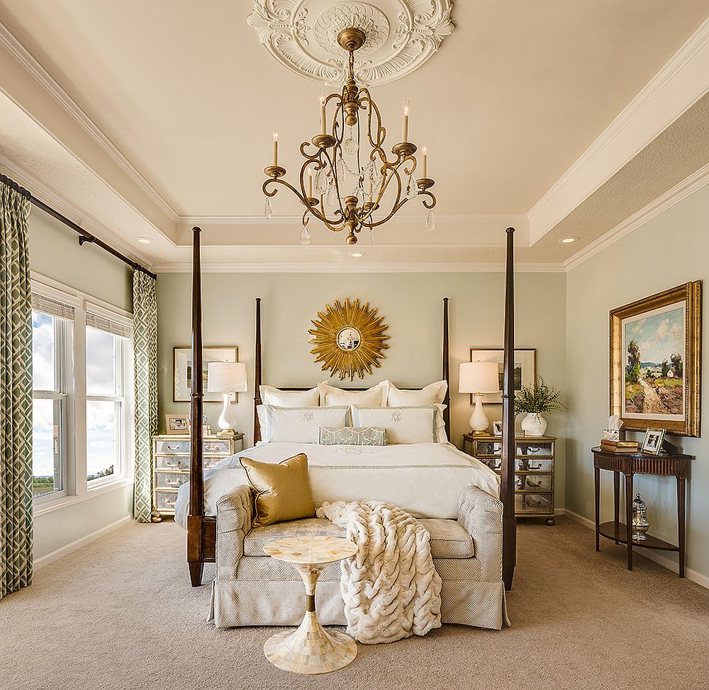 Gorgeous and comfortable bedroom with sunburst mirror and lovely chandelier