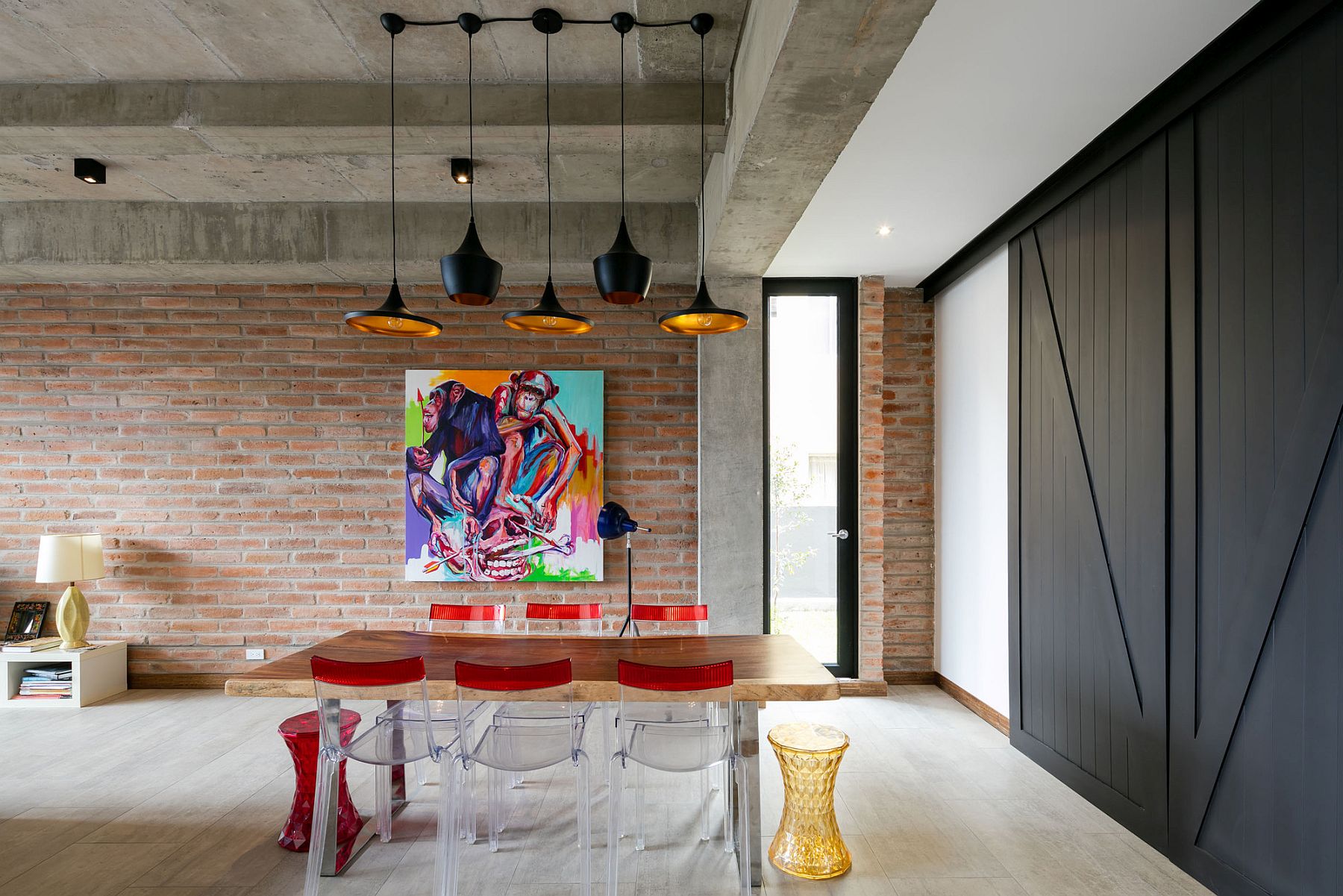 Gorgeous-dining-room-with-Tom-Dixon-lighting-brick-wall-backdrop-and-concrete-ceiling