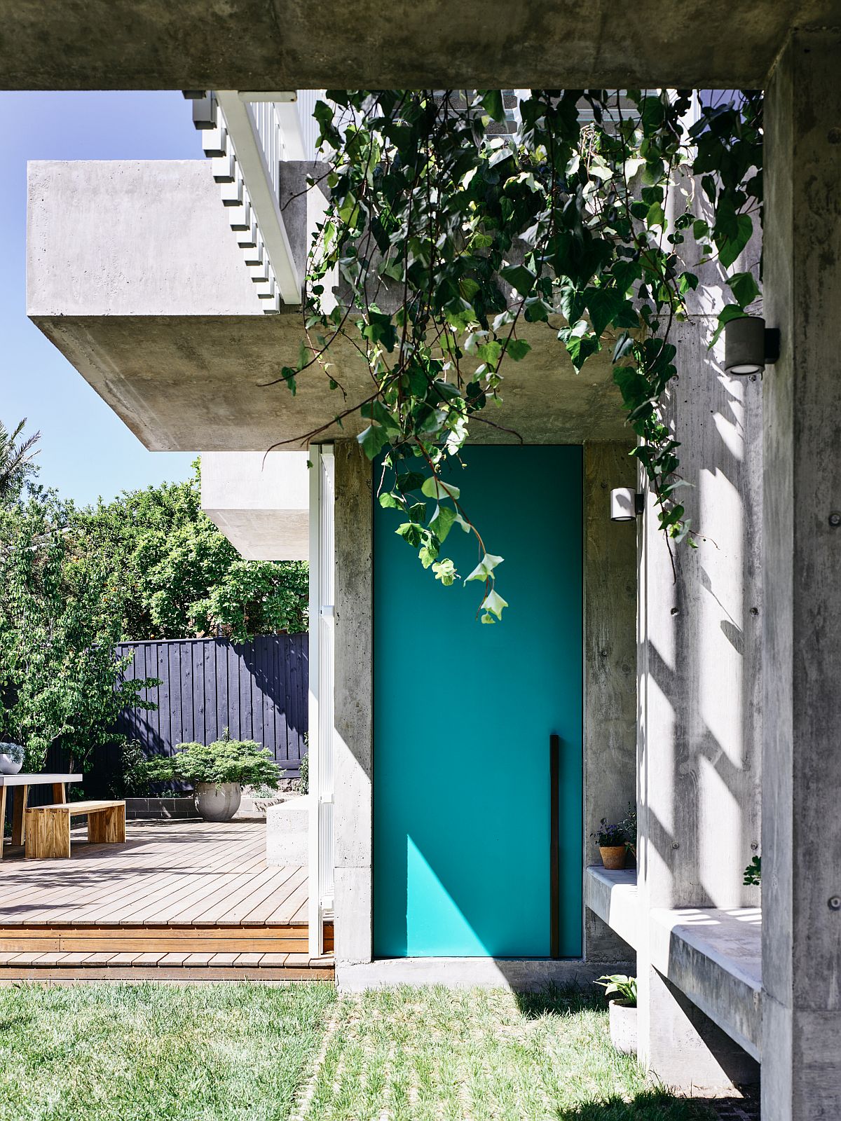 Hanging plants and grasscrete welcome you at this modern Kew Residence