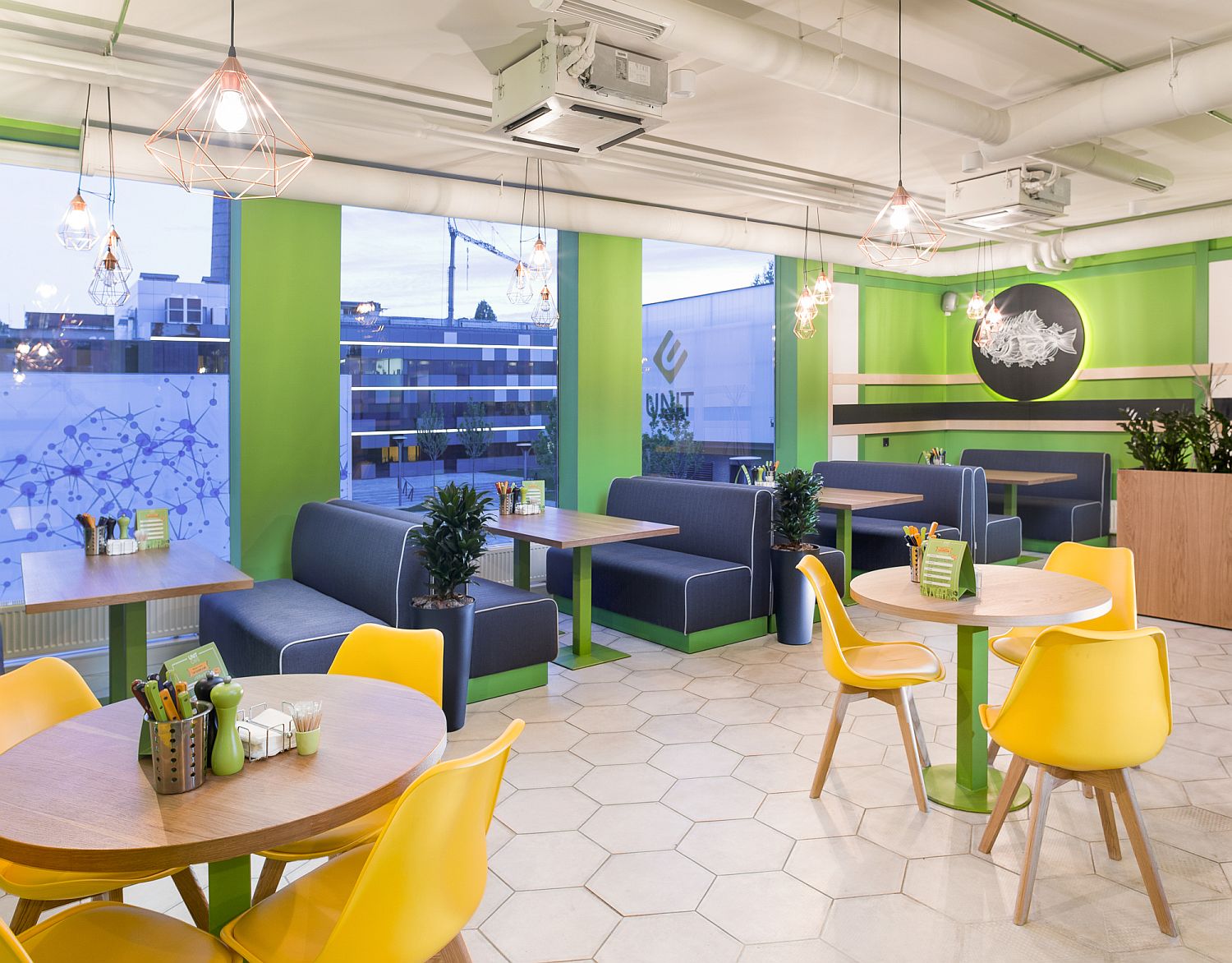 Interior with green and pops of yellow with hexagonal tiled flooring and geo accents