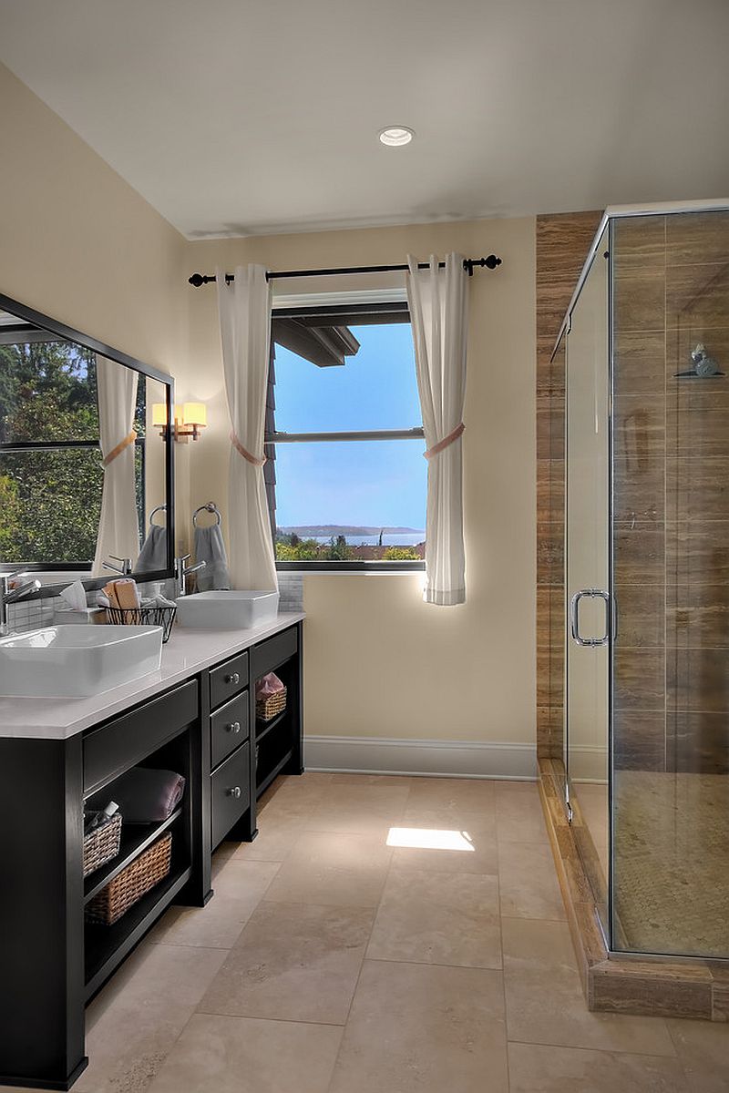 Large black vanity with ample storage space and open shelves for the traditional bathroom