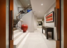 Large-contemporary-entry-in-white-with-pops-of-orange-and-a-bold-floor-vase-217x155