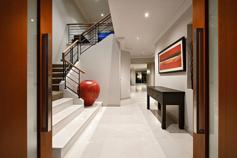 Large-contemporary-entry-in-white-with-pops-of-orange-and-a-bold-floor-vase