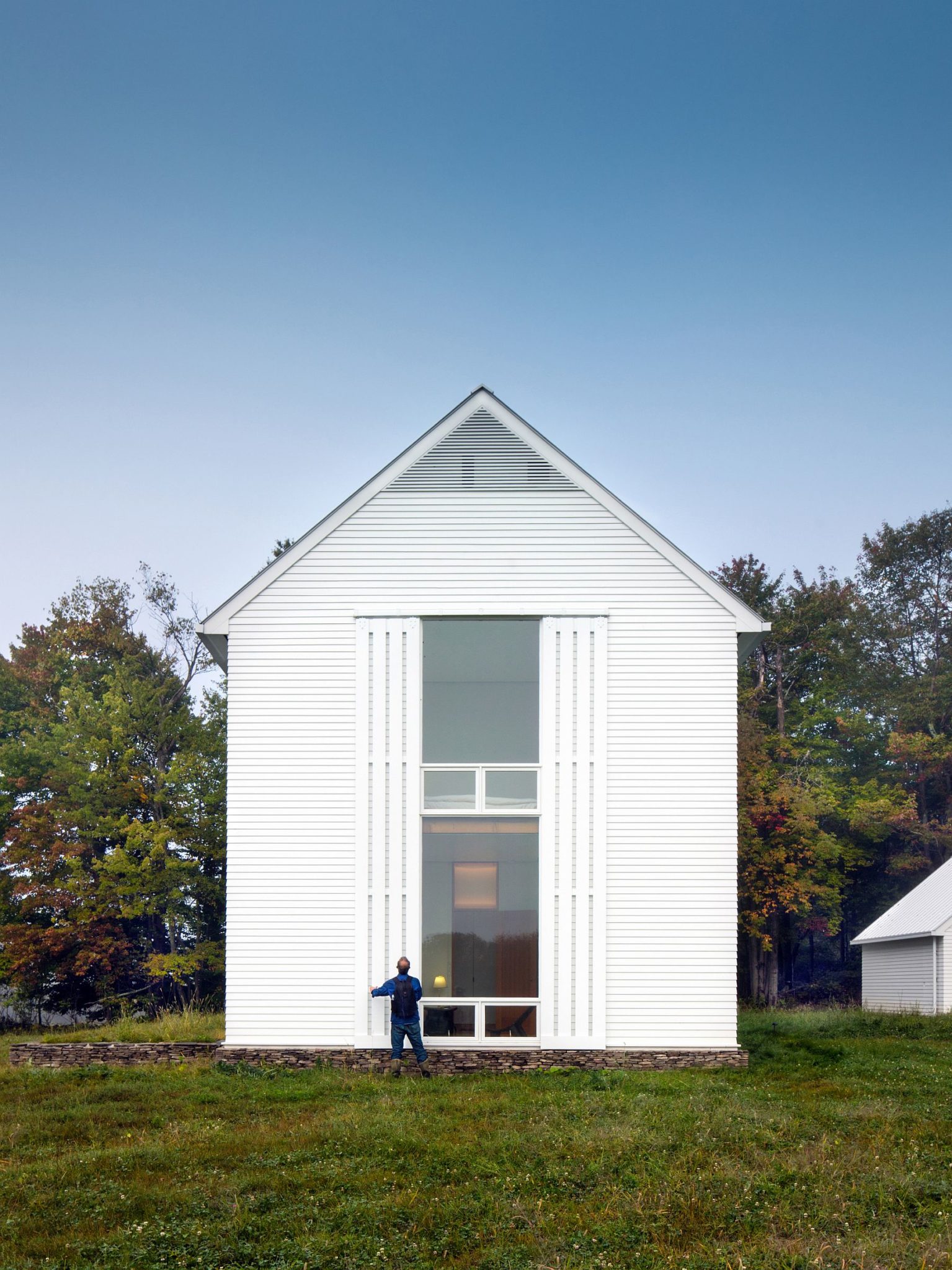 Large glass windows and rolling screens create a lovely home in Pennsylvania