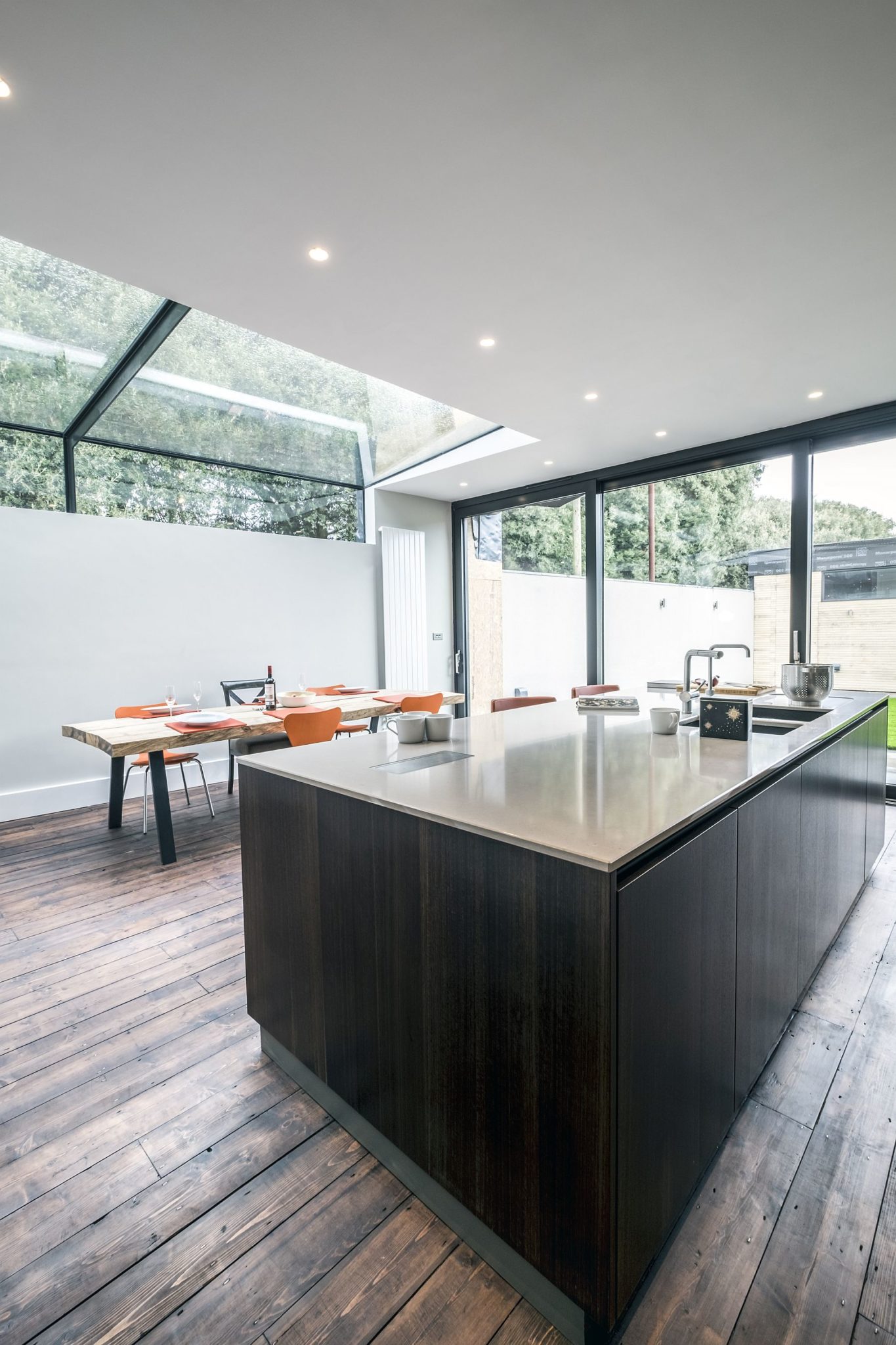 Light-filled kitchen and dining of the Victorian home in Eucalyptus wood and gray