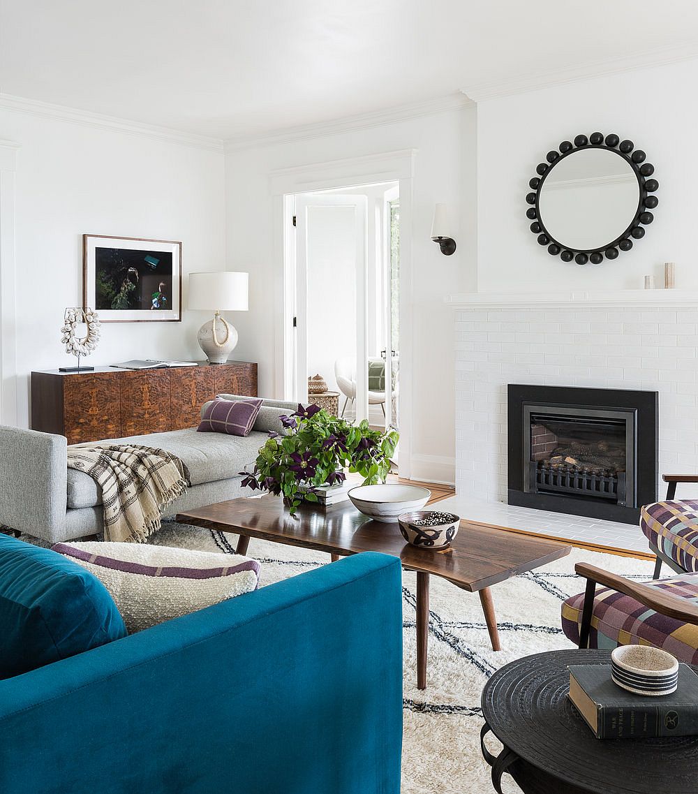 Live-edge coffee table, blue couch and a chic rug shape the stylish living room