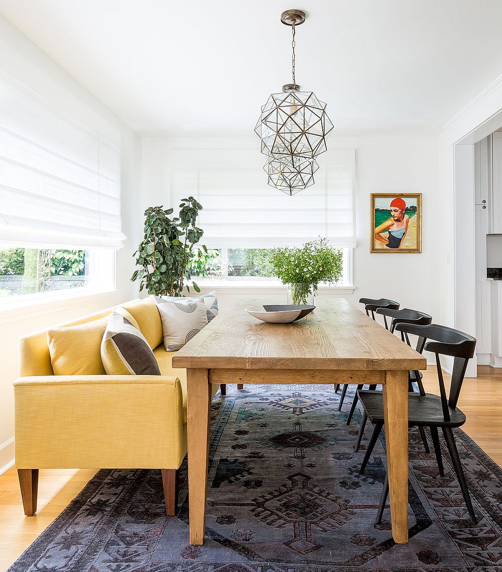 Luxurious seating and colorful rug create a cozy, charming dining room