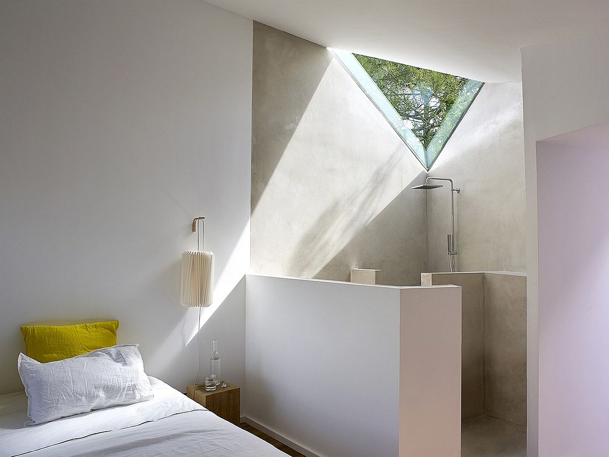 Minimal-bedroom-with-shower-area-in-the-corner-in-white