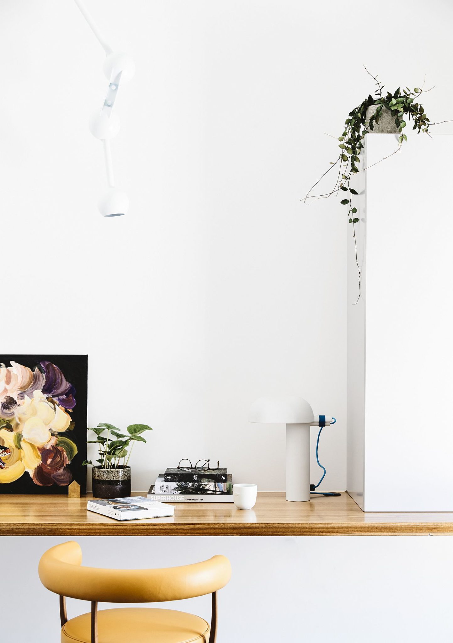 Minimal white walls and wooden plank create an interesting workspace