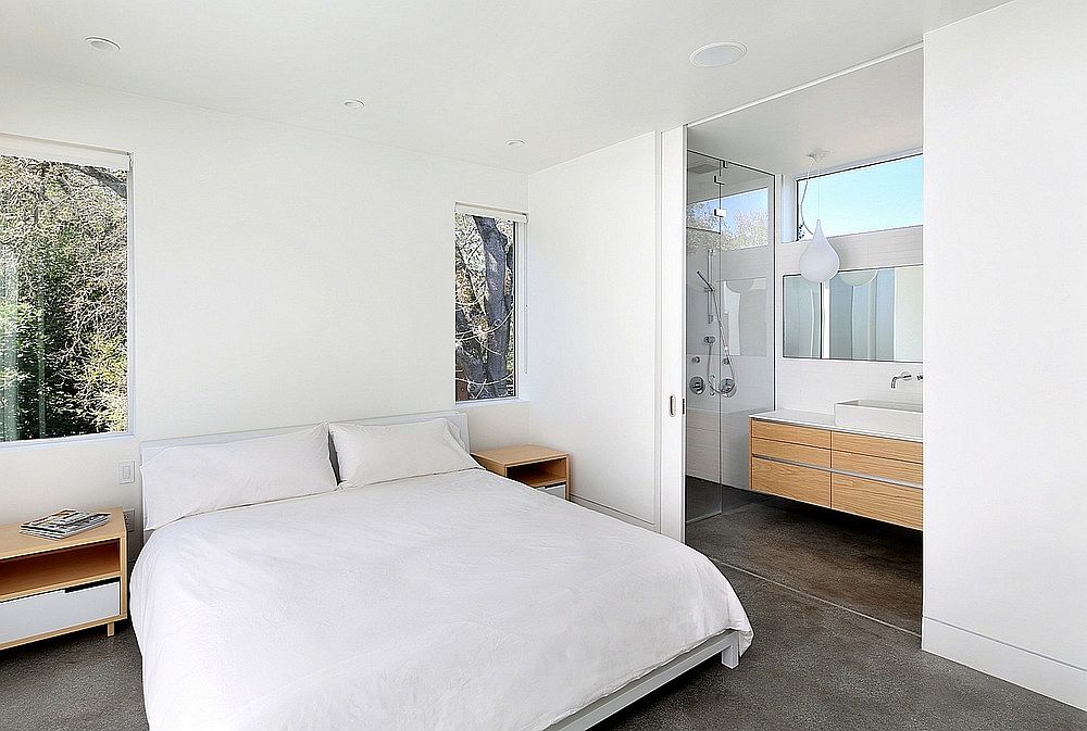 Modern bedroom in white with a view of the canopy outside