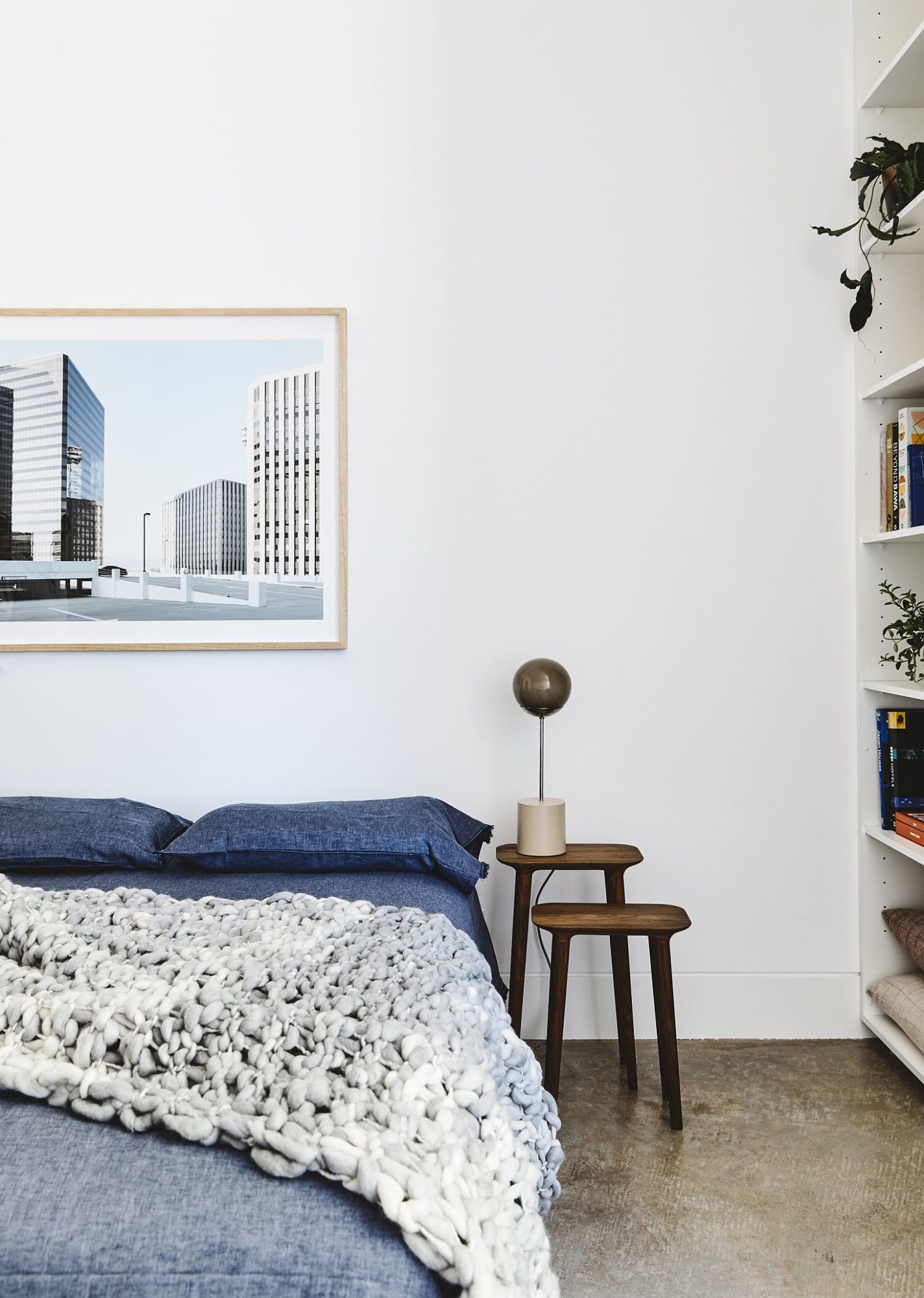 Modern bedroom in white with pops of blue