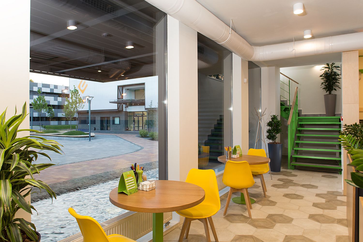 Modern industrial elements along with bright color shape the cafe interior