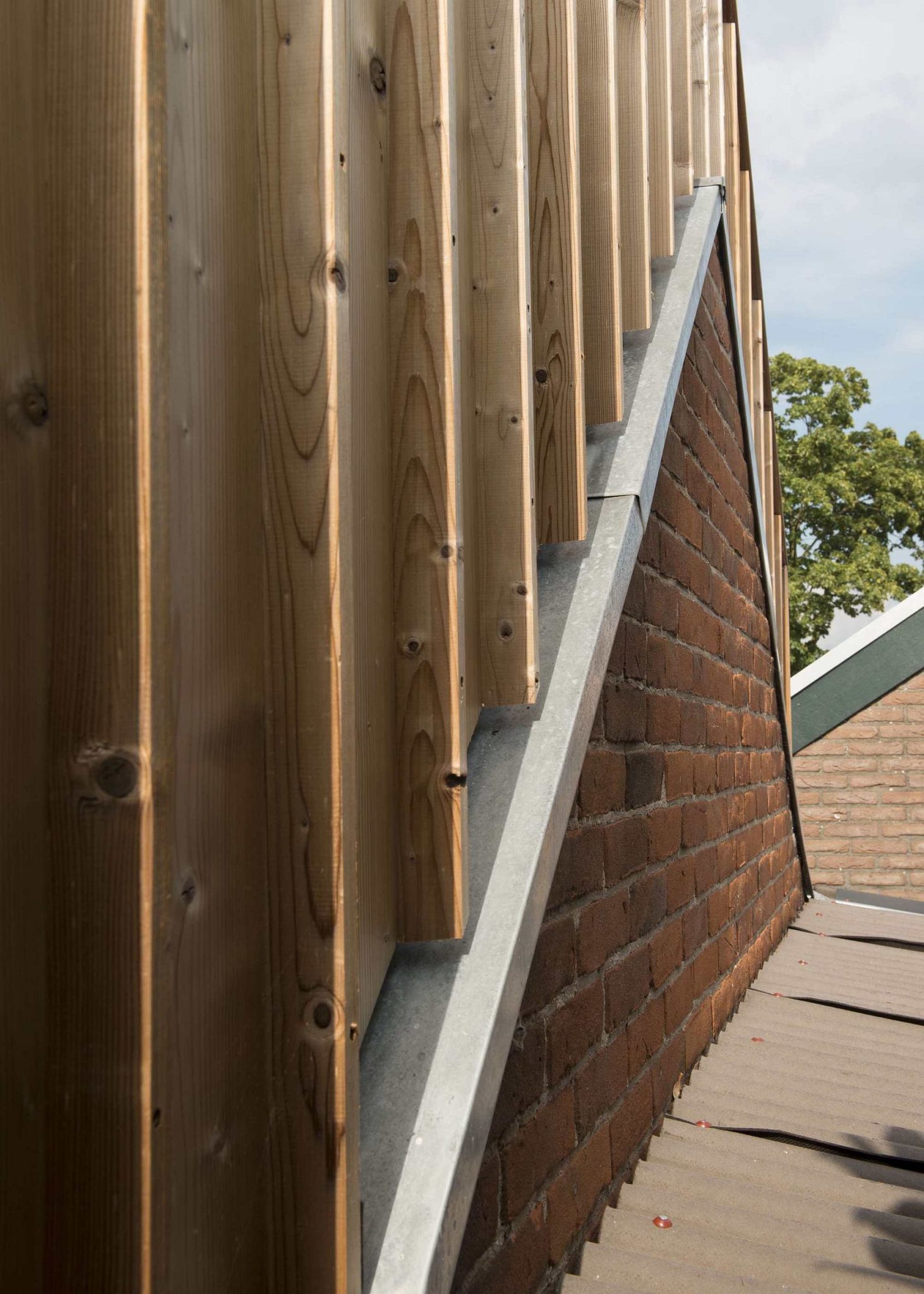 Modern wooden volume combined with brick shed walls to create a lovely studio