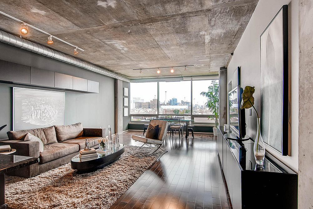 concrete ceiling accented by open ductwork and pipes