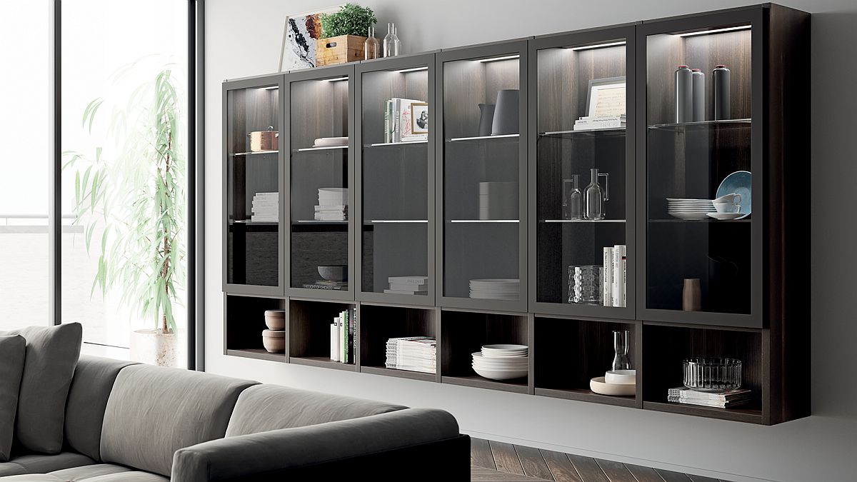 Open shelving units coupled with cabinets with glass doors for the living room display