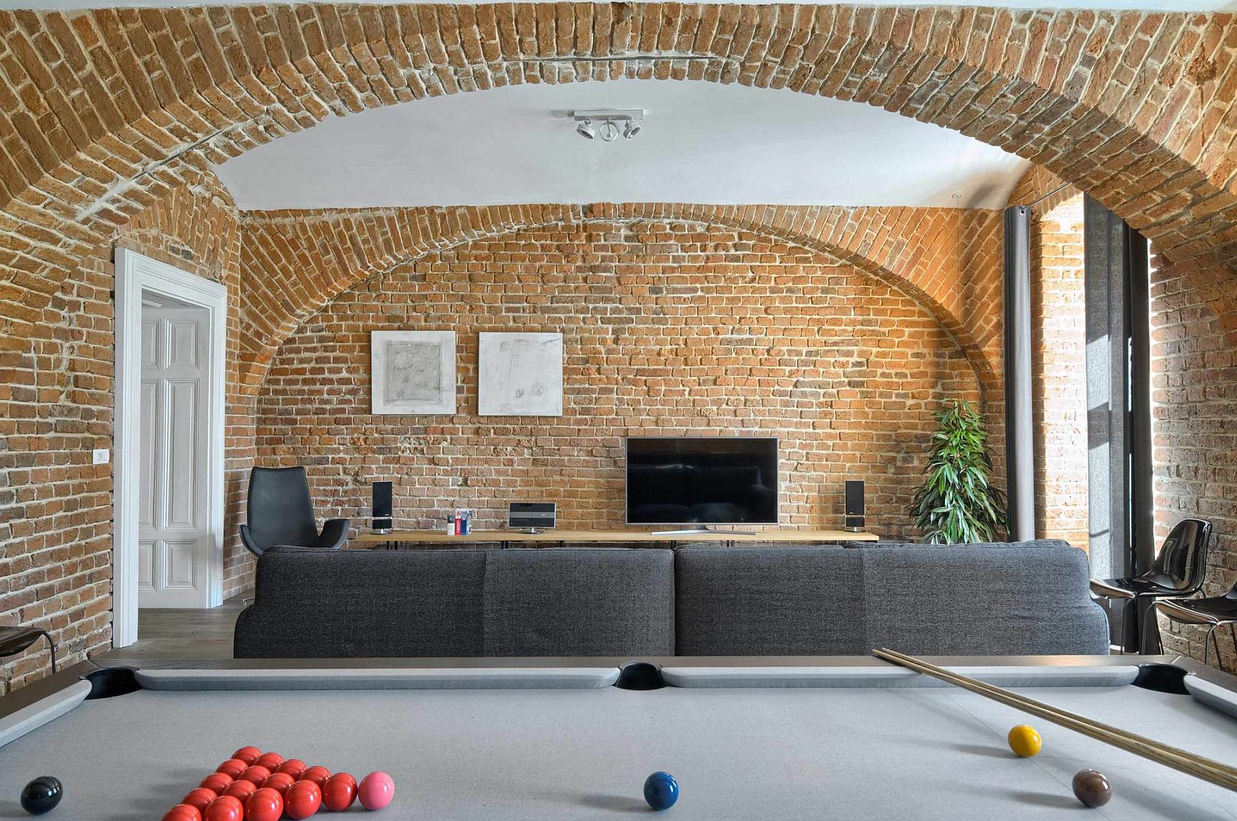 Original-exposed-brick-walls-of-the-restored-apartment-steal-the-show-here