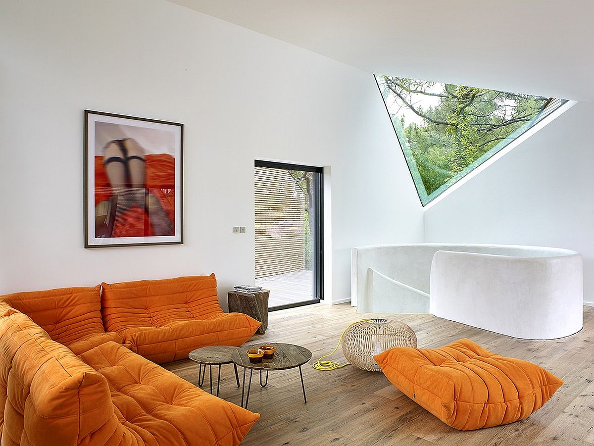 Plush sofa in orange for contemporary interior in white