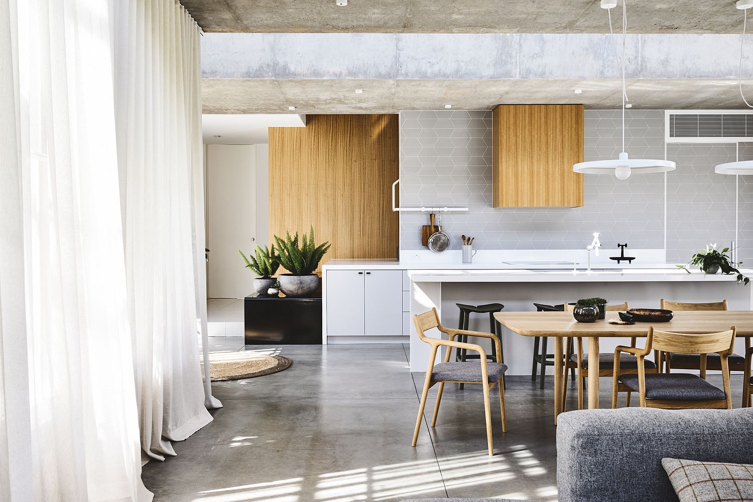 Polished and light-filled dining area and kitchen of the Melbourne home