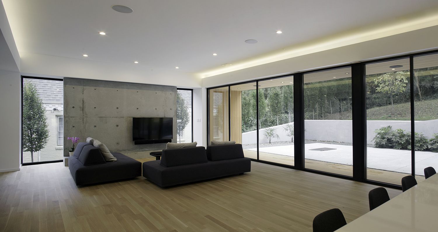 Polished-and-minimal-living-area-with-concrete-television-wall