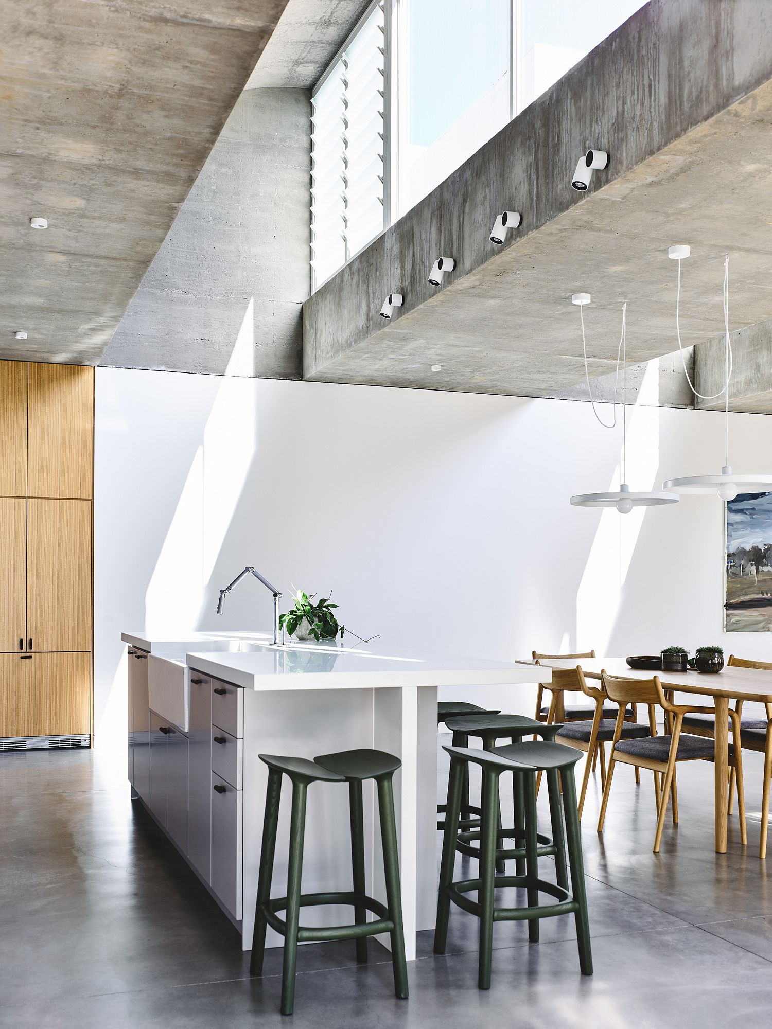 Polished concrete floor and exposed concrete ceilings give the interior a minimal appeal