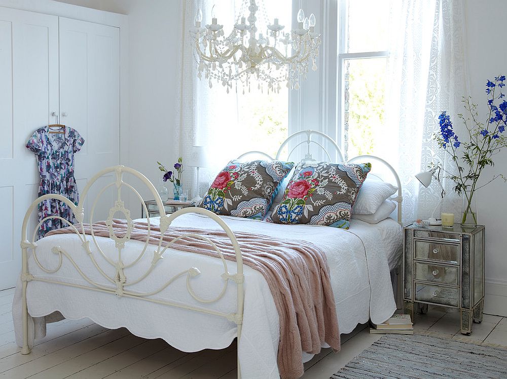 Shabby chic bedroom with a chandelier that blends into the backdrop