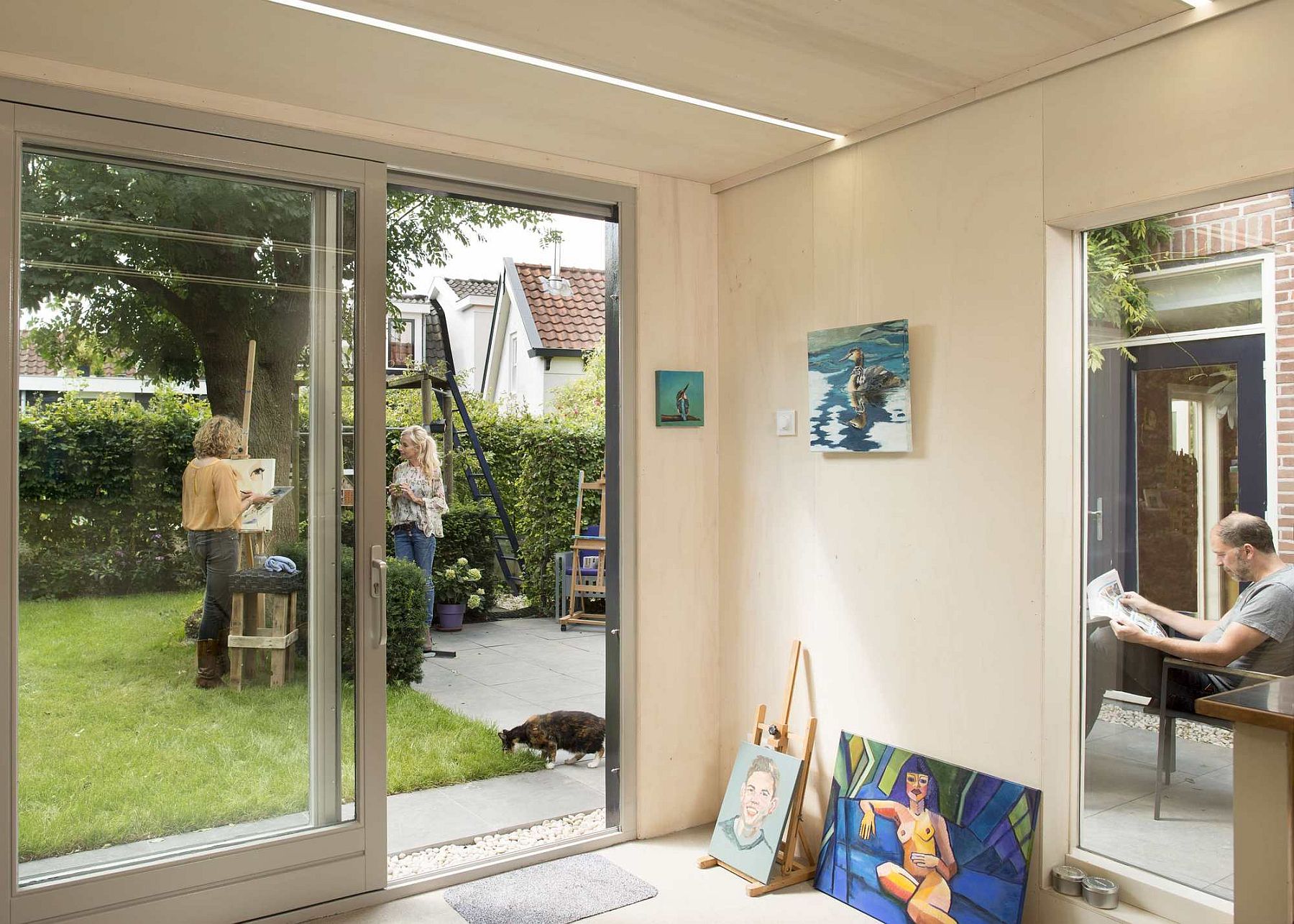 Sliding glass doors connect the interior with the garden