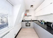 Space-savvy-L-shaped-kitchen-in-white-with-black-countertop-217x155