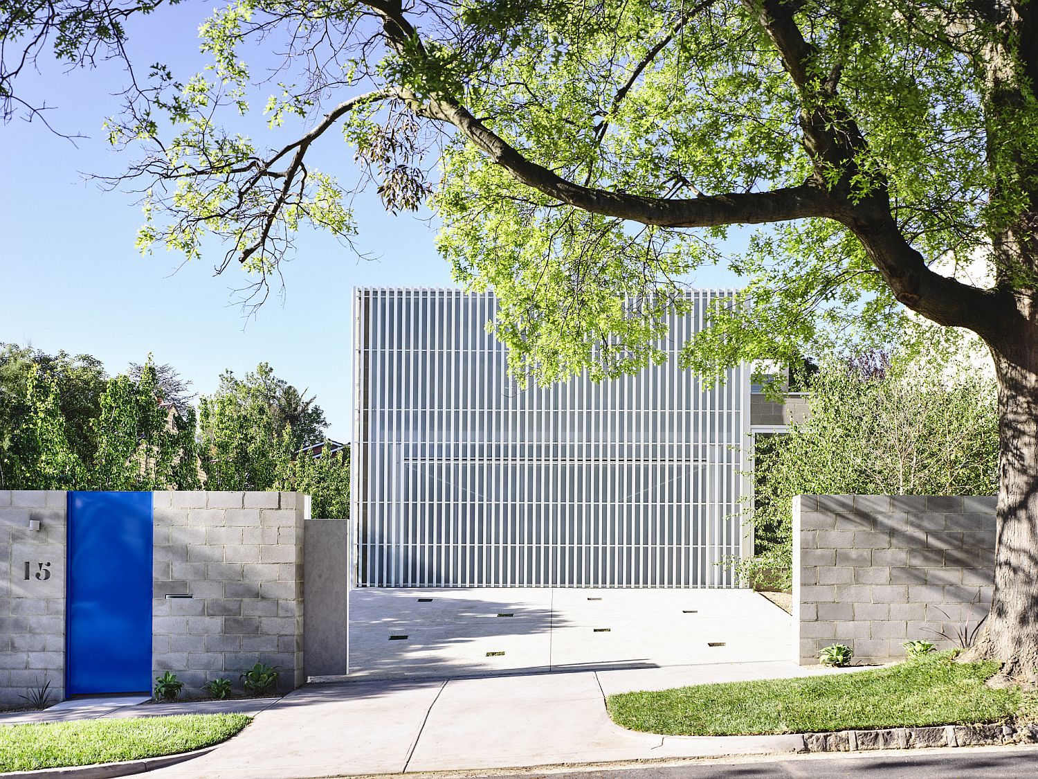 Street facade of the Moving House in Melbourne with a white metal grille