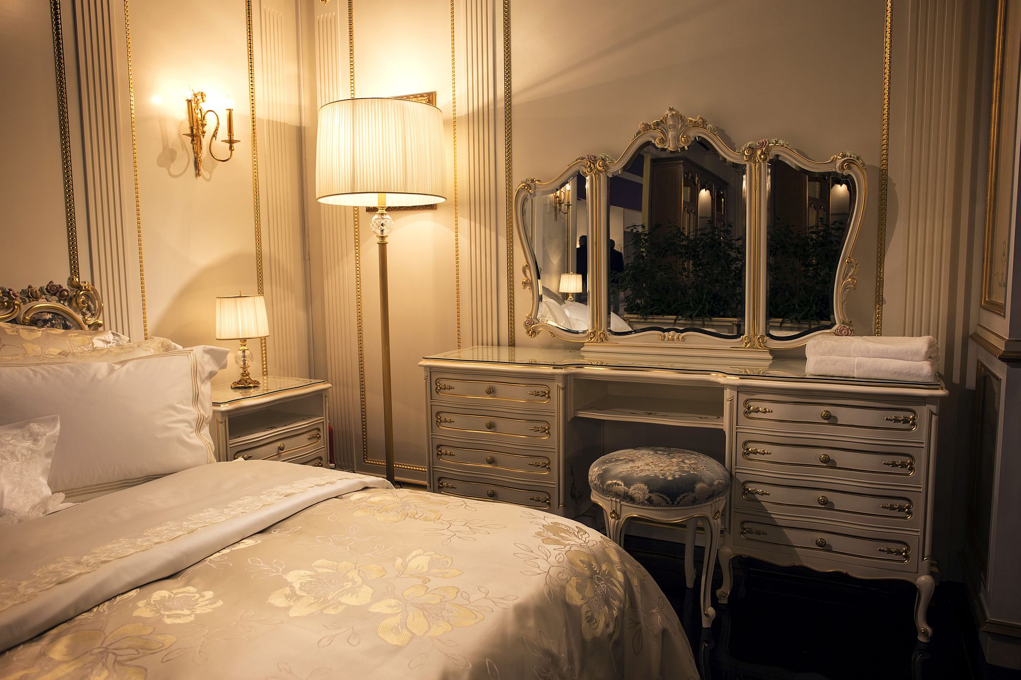 Traditional bedroom dresser with matching mirror and a simple stool